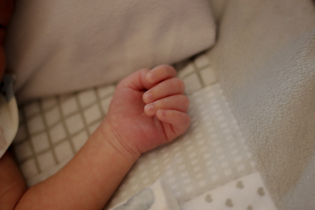 a close up of a baby laying in a crib