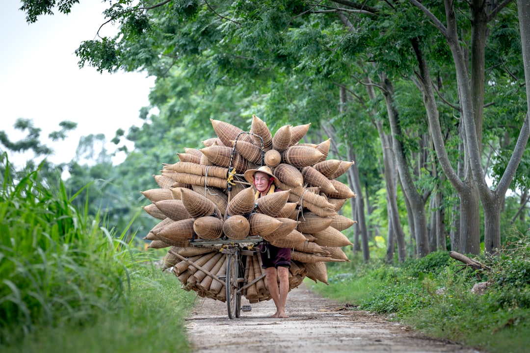 a person riding a bike with a bunch of bags on the back of it
