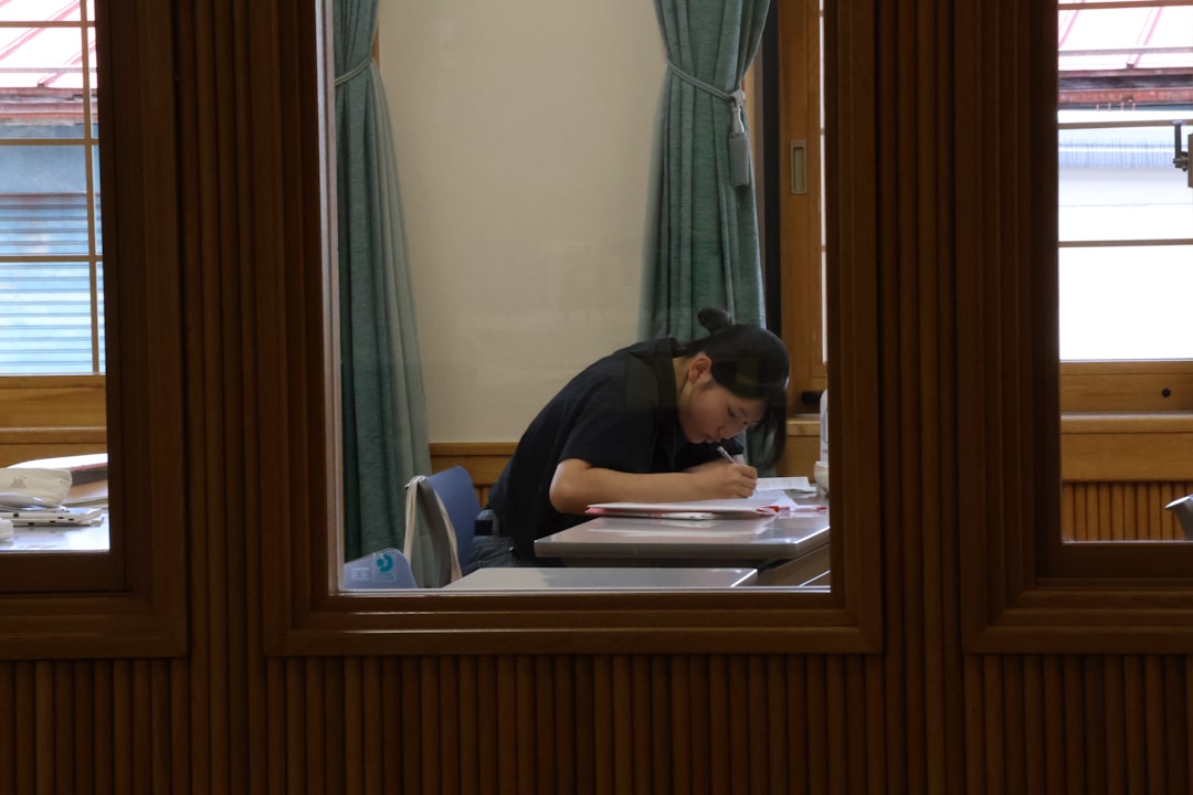 A person studying at a desk with books.