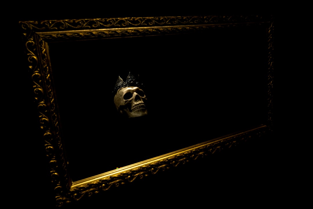 a picture of a skull in a gold frame