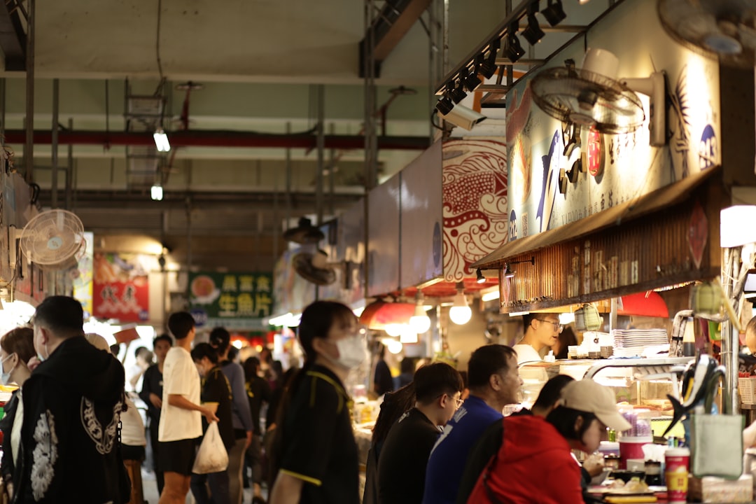People browsing stalls in a busy indoor market.